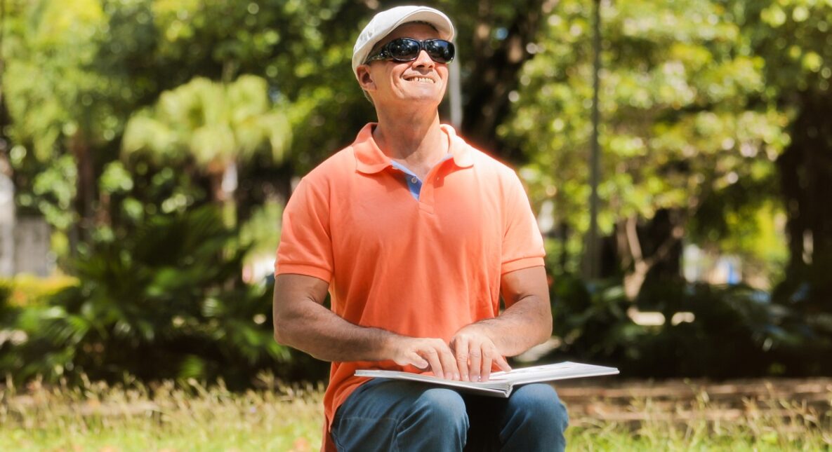 A blind man using braille to read.
