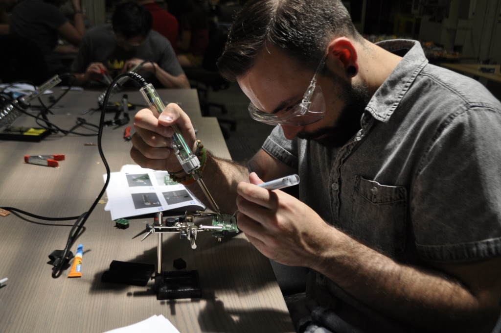 A man building a LipSync device.