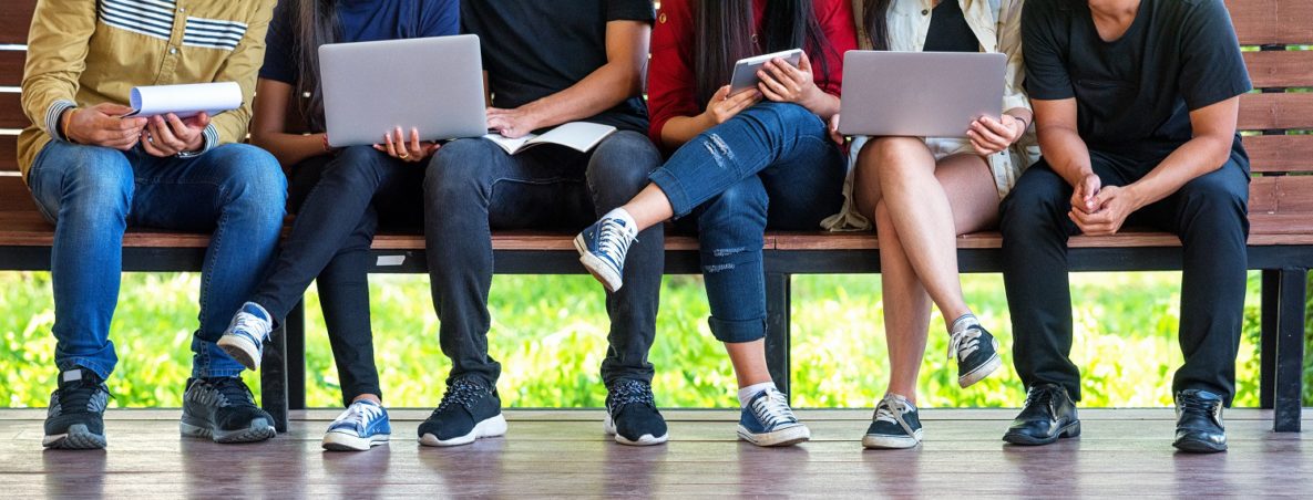 A group of students using laptops and tablets.