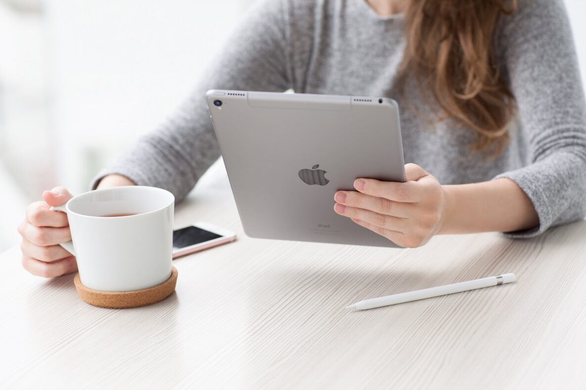 A woman using an iPad and Apple Pencil.