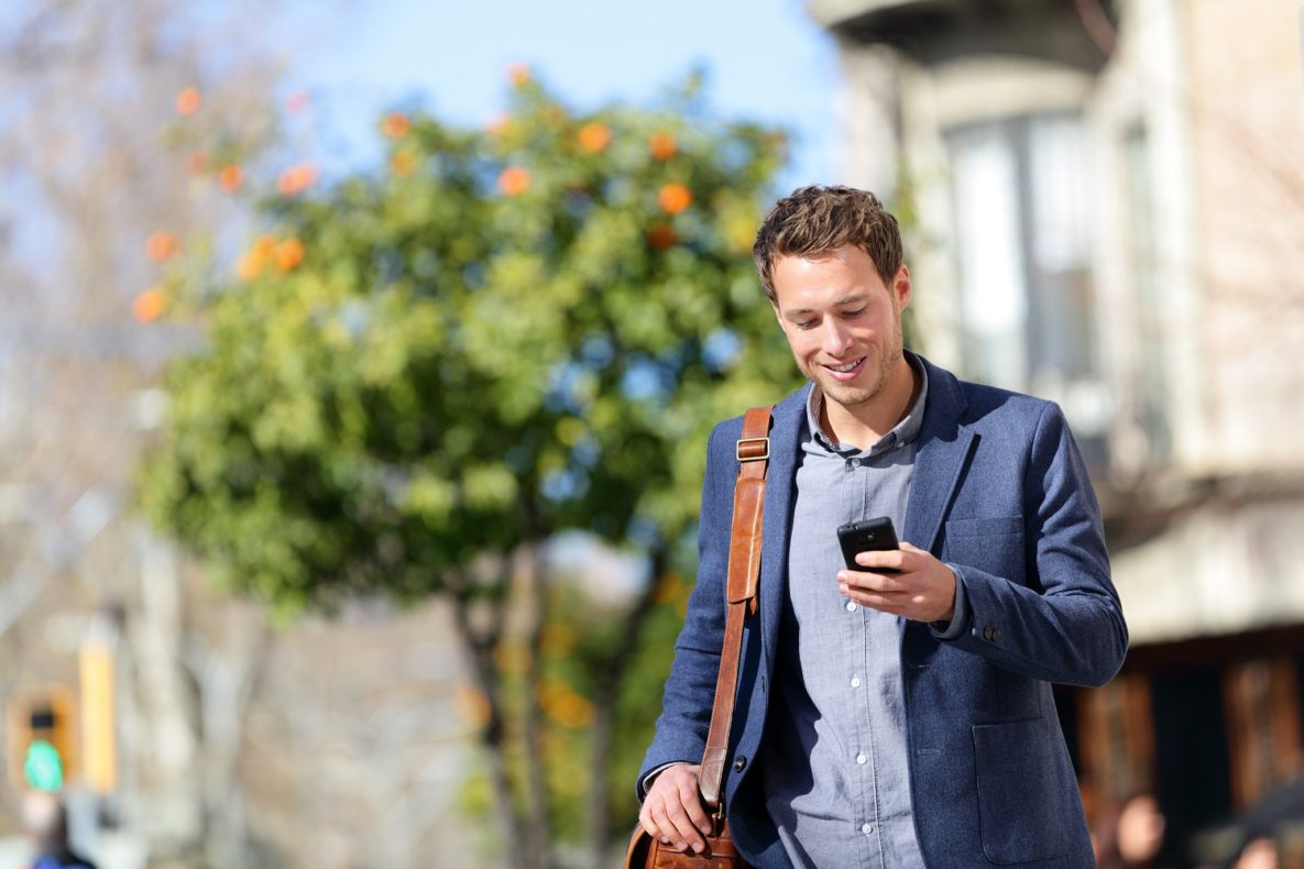 A man looking at a smartphone.