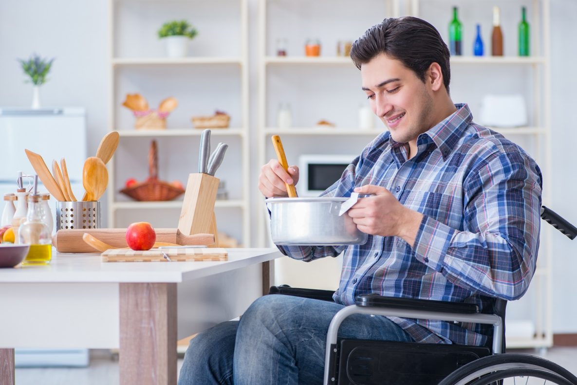 A disabled man cooking.