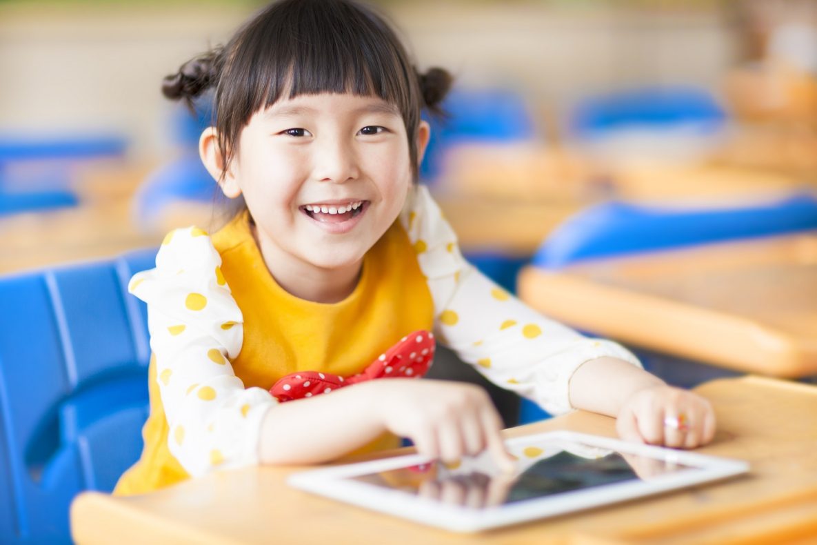 A girl using an iPad in the classroom.
