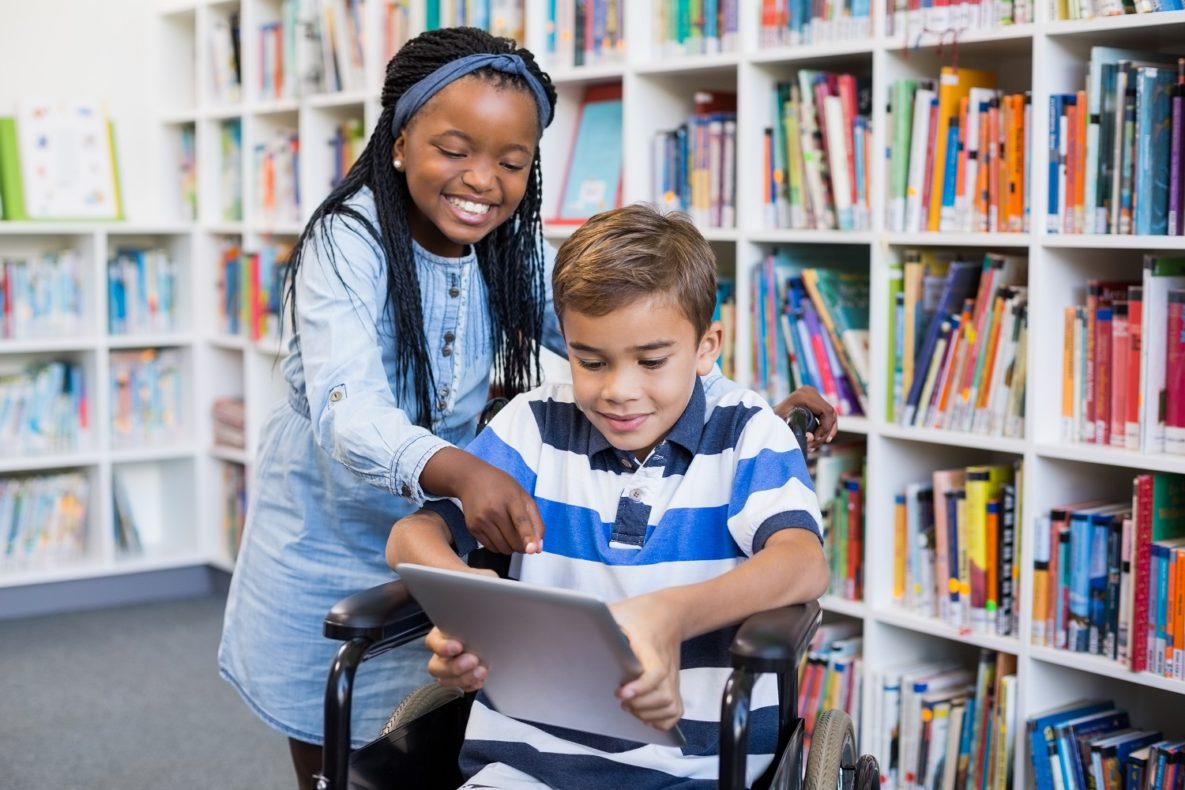Two children communicating using assistive technology.