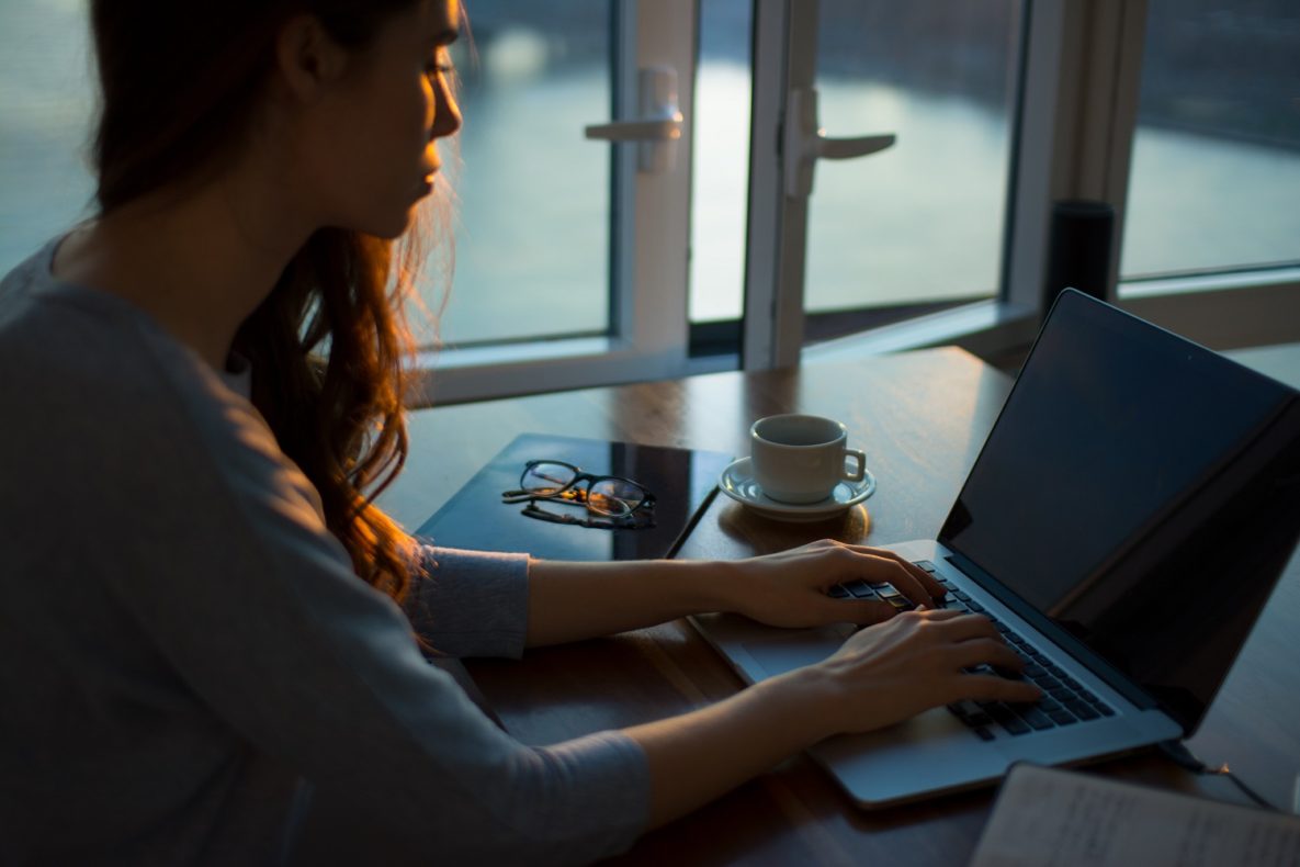 A woman using her computer to work from home.