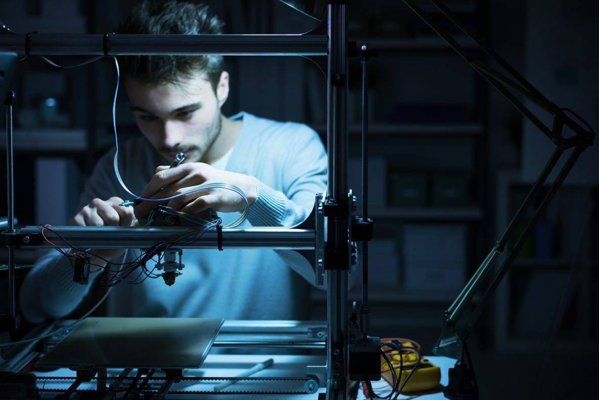 A person working with a 3D printer.