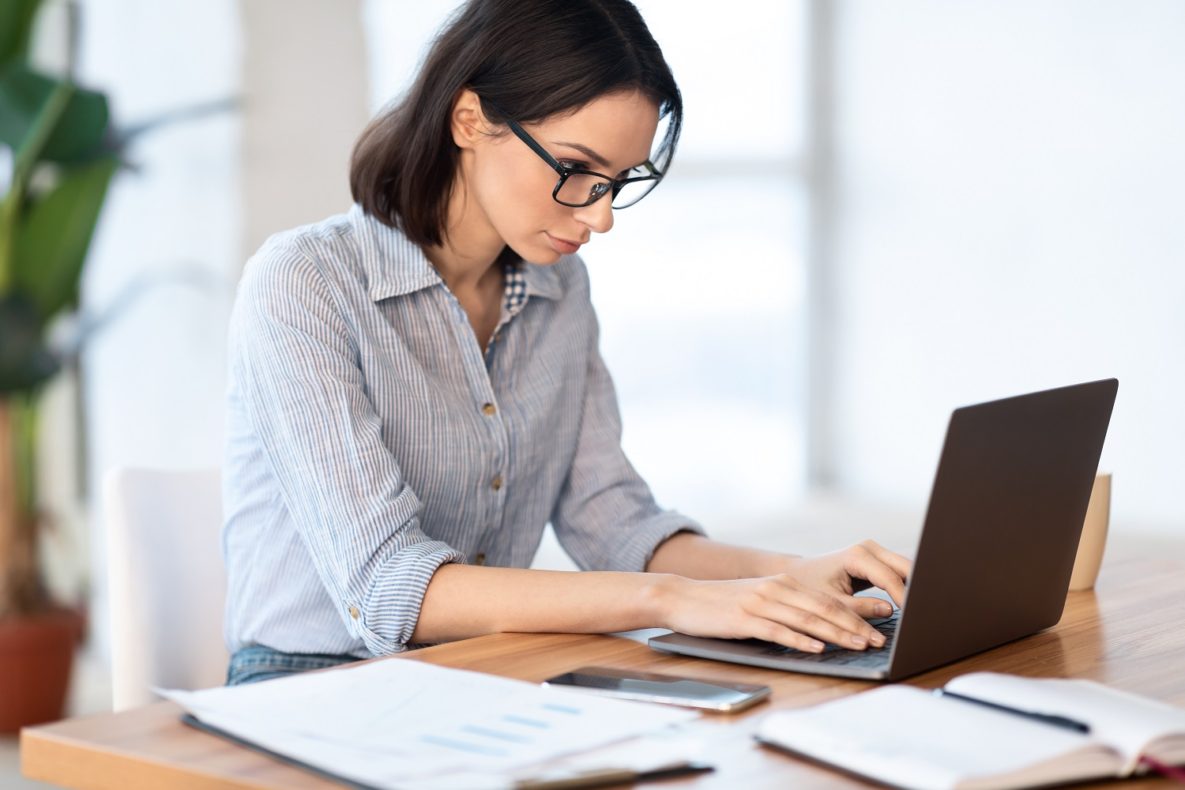 A woman at work using her laptop.