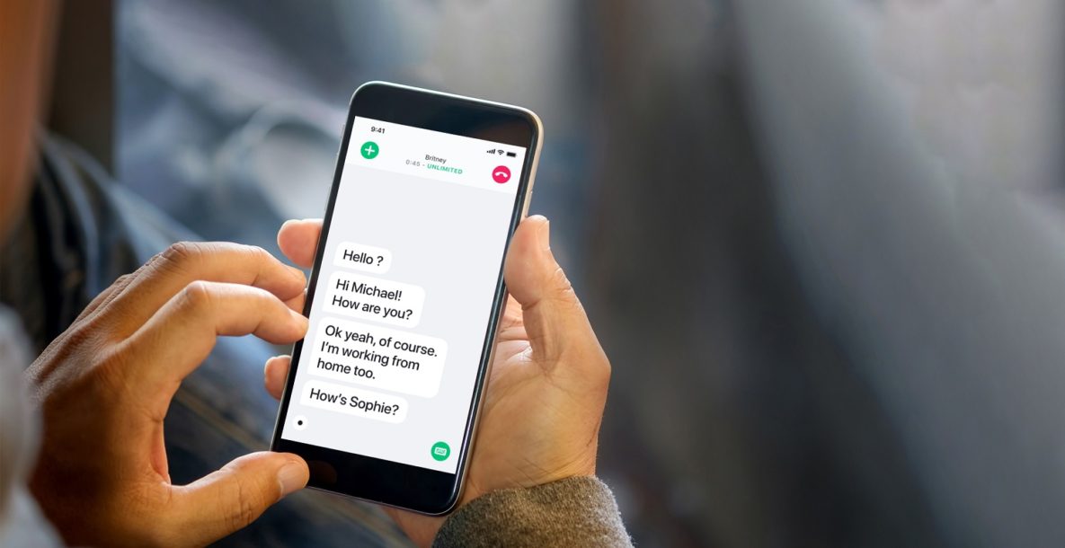A man using a captioning system on a phone call.