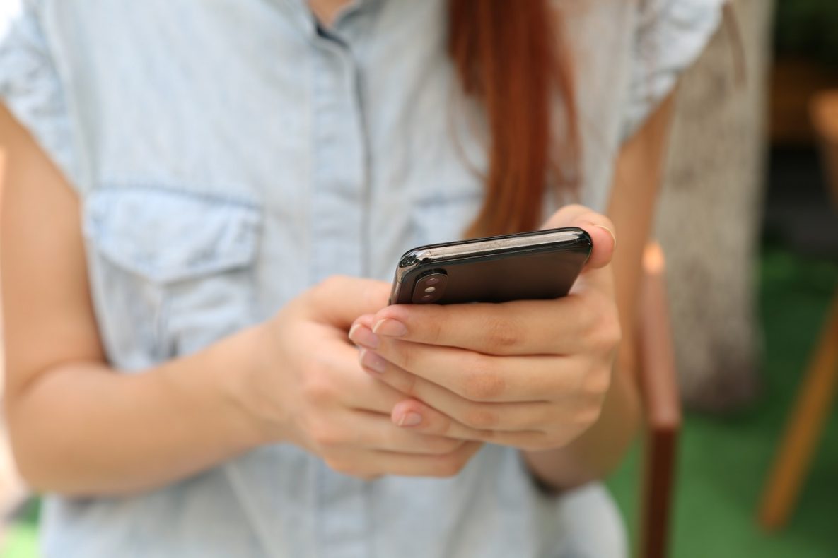 A woman using her voice to control her smartphone.