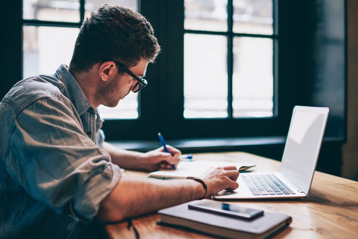 A man using a laptop to study.