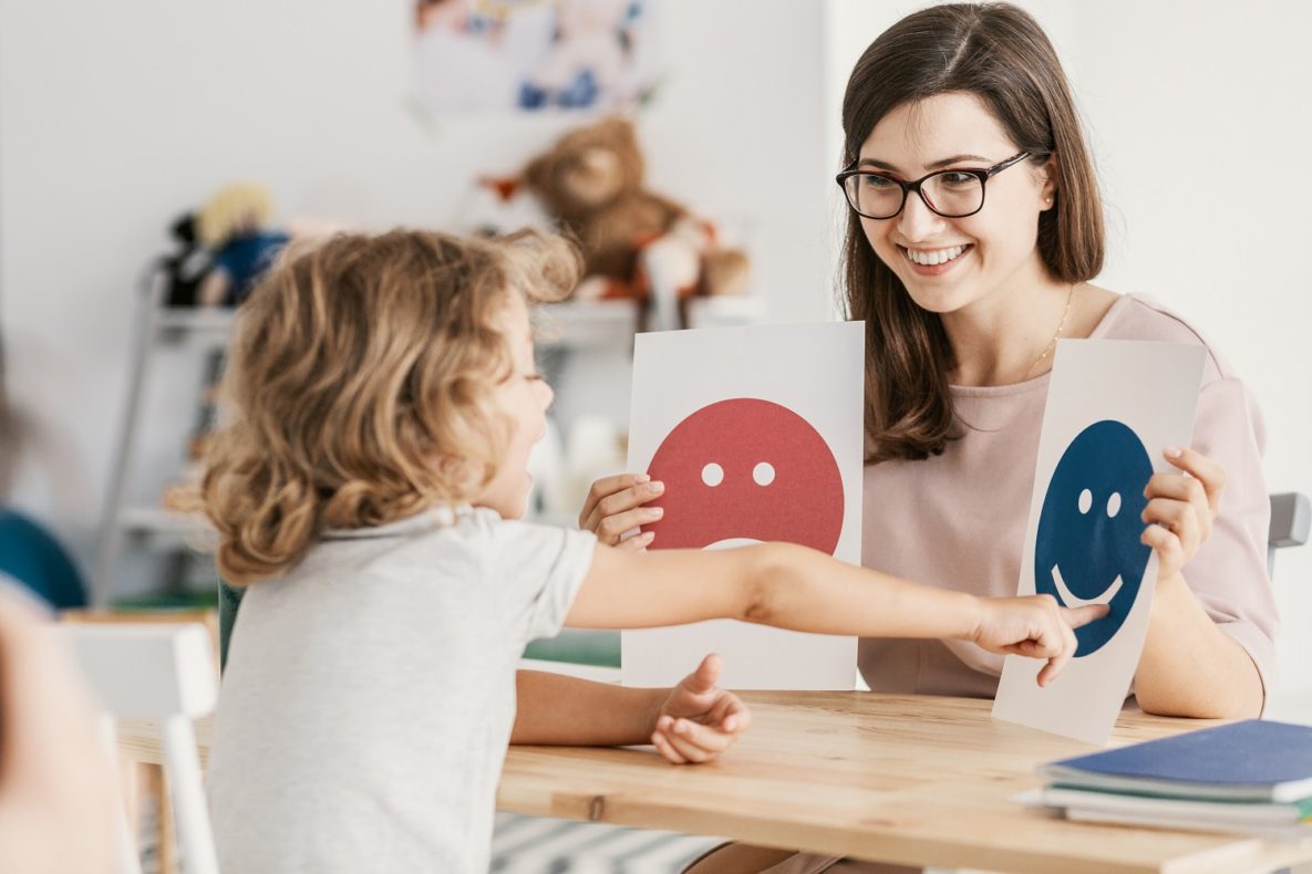 A teacher and student using symbols to communicate.