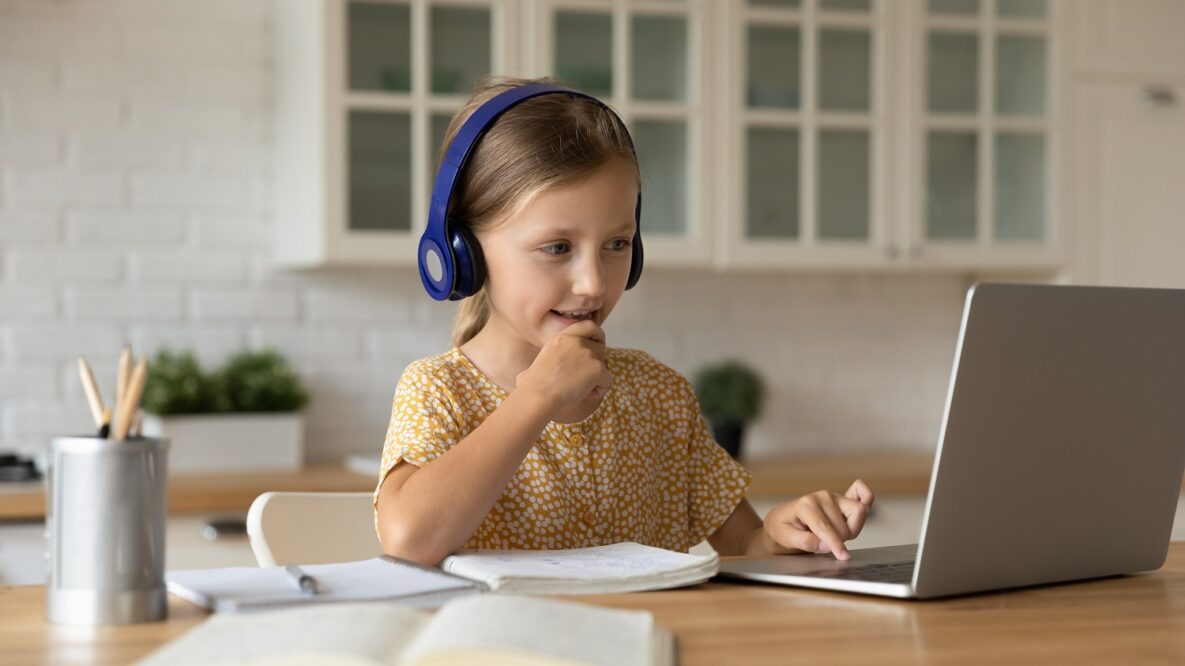 A young girl learning at home.