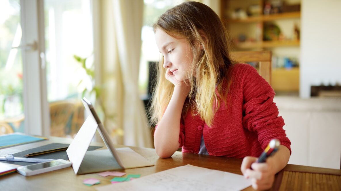 A girl using her tablet to study.