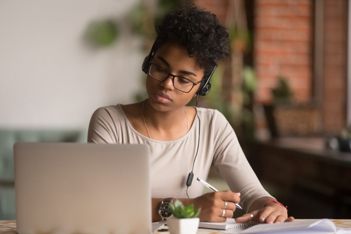 A young woman using a laptop to study.