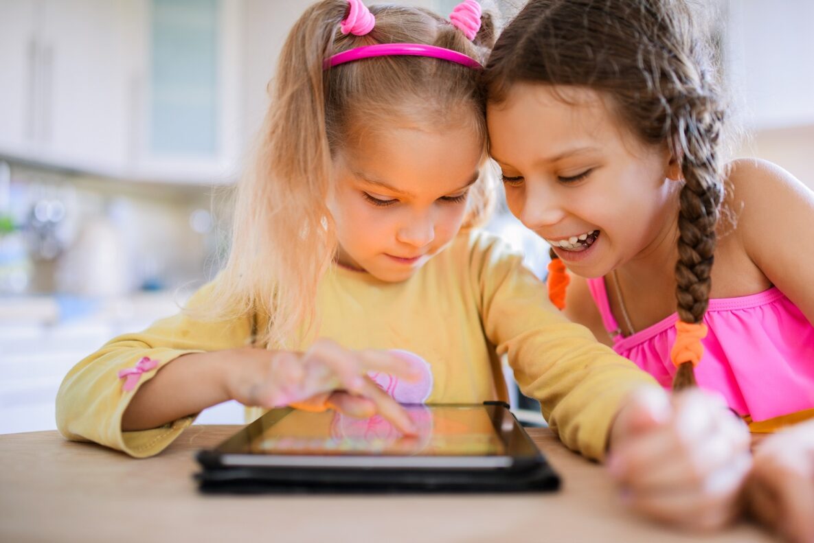 Two girls using a tablet.