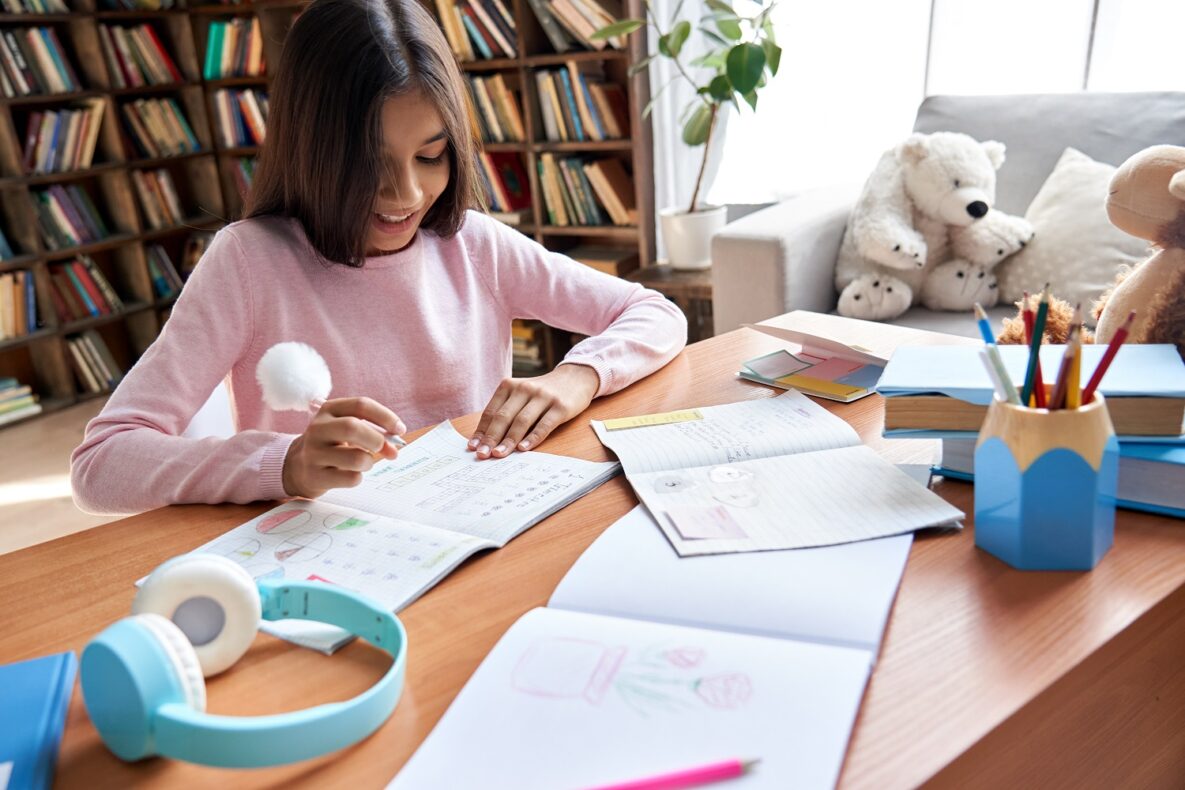 A young girl studying with notes.