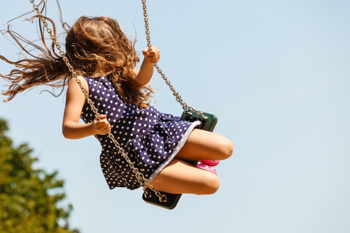 A young girl on a swing.