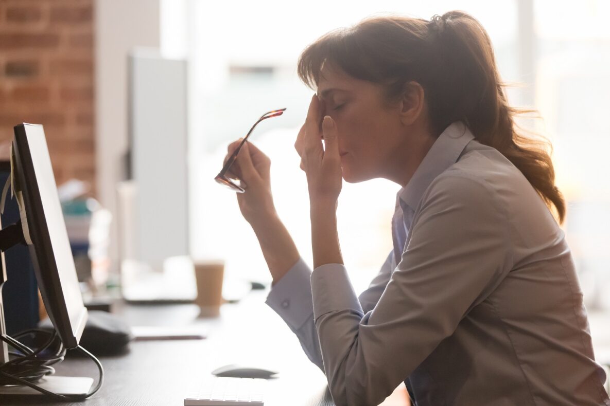 A stressed-out woman at her desk.