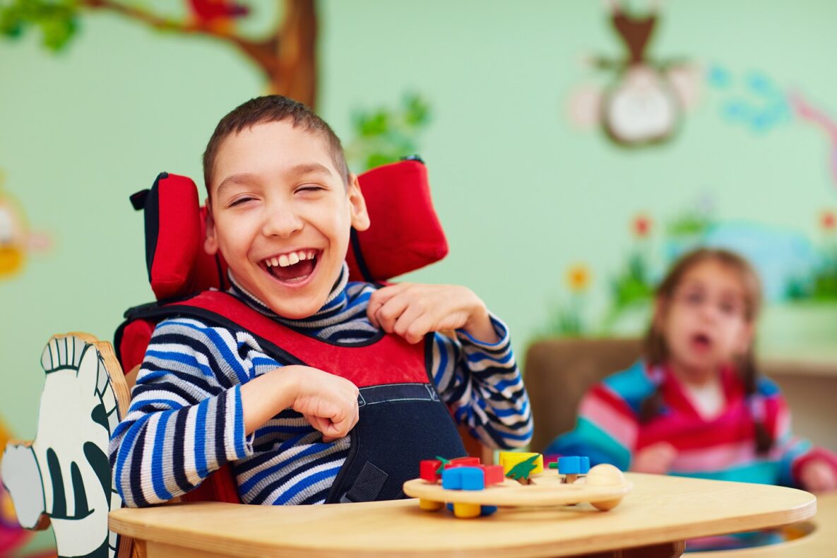 A smiling boy in a wheelchair.