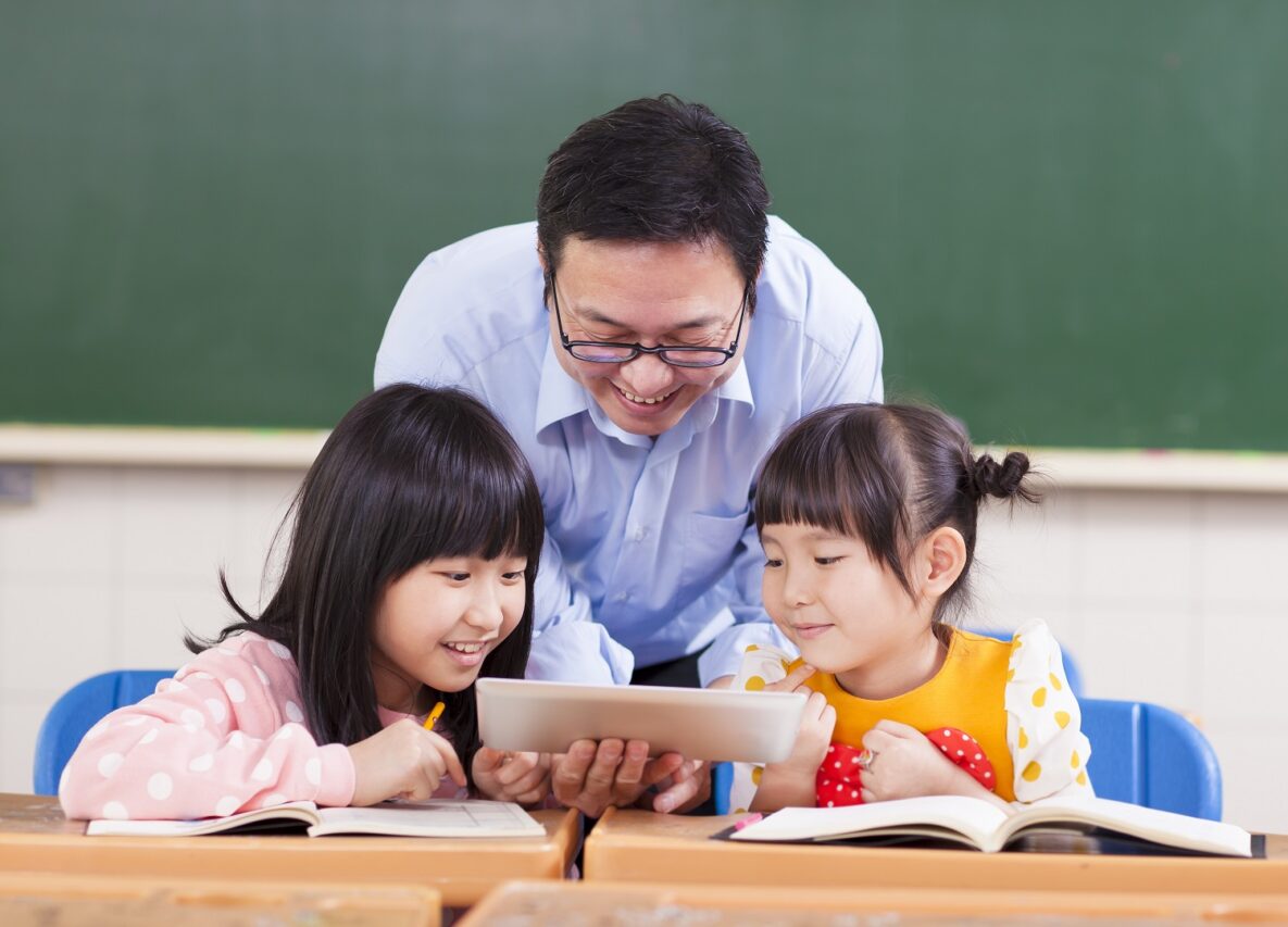 A teacher helping his students.