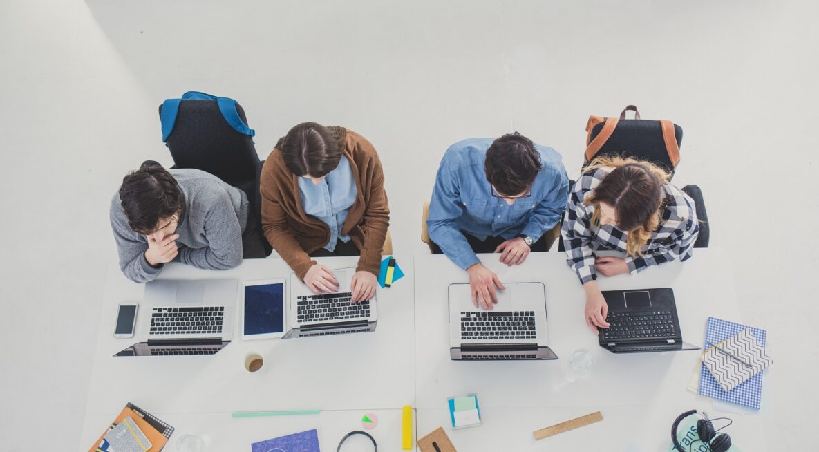 A group of students studying on their laptops.