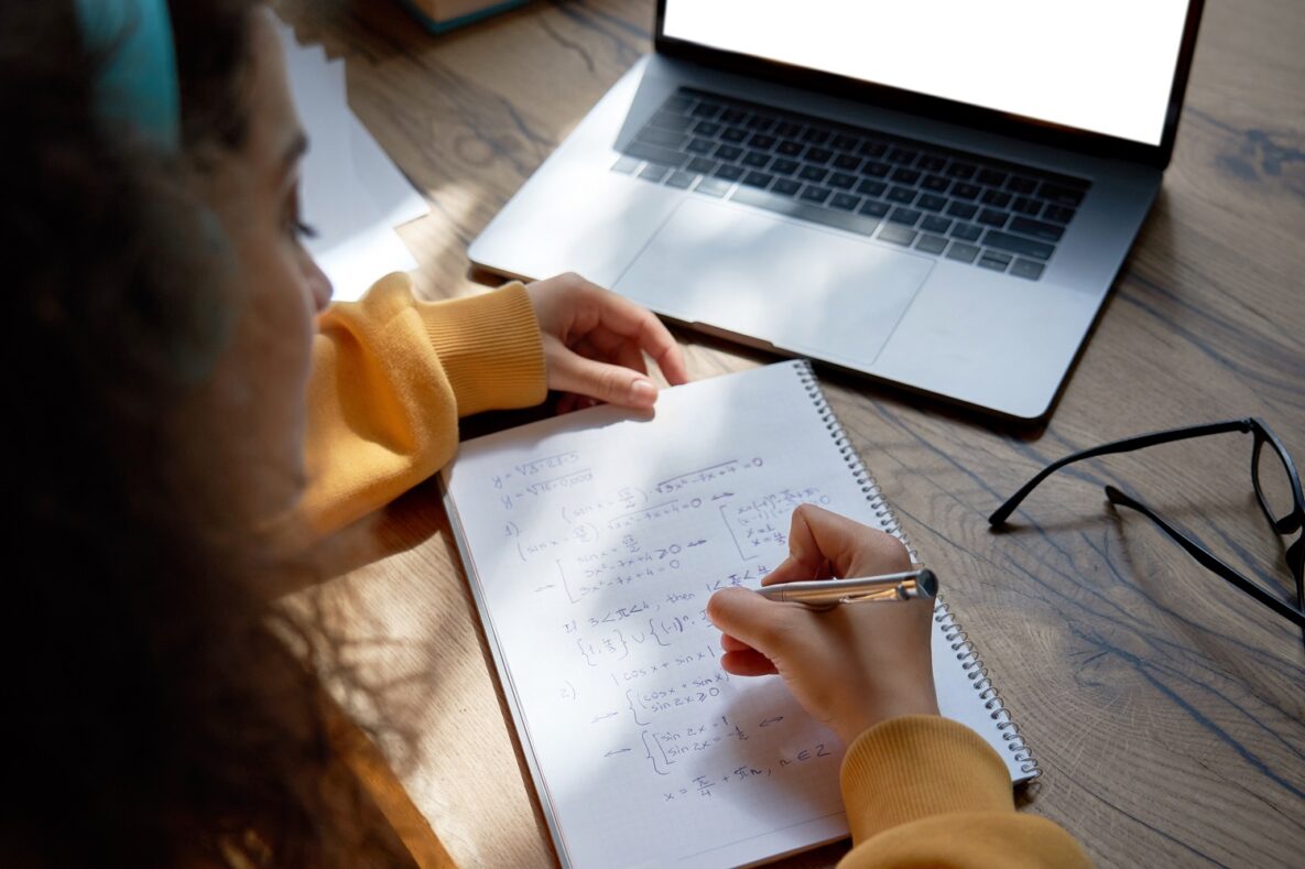 A young woman studying on her laptop.