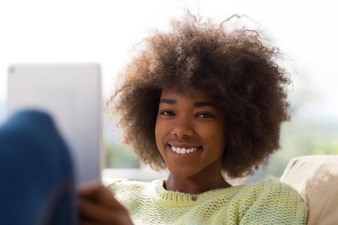 A woman using technology at home.