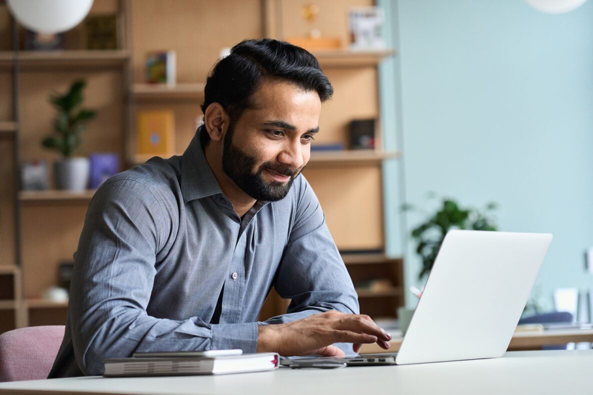 A man using his laptop at work.