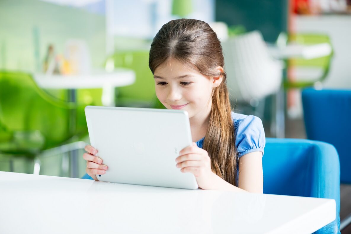 A young woman using her tablet in class.
