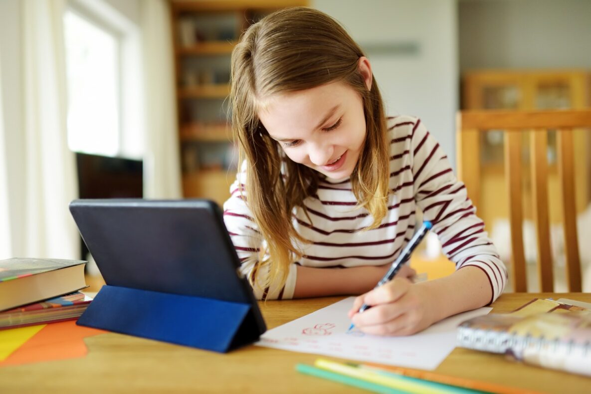 A young woman using her tablet to study.