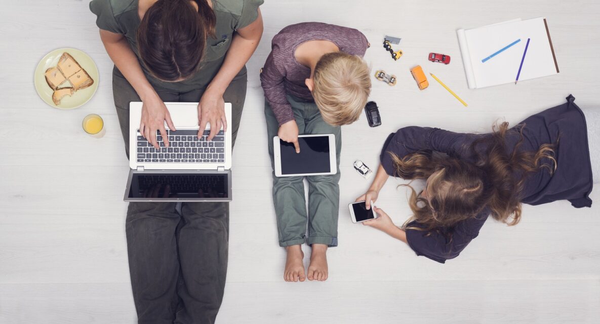 A family sitting together using their devices.