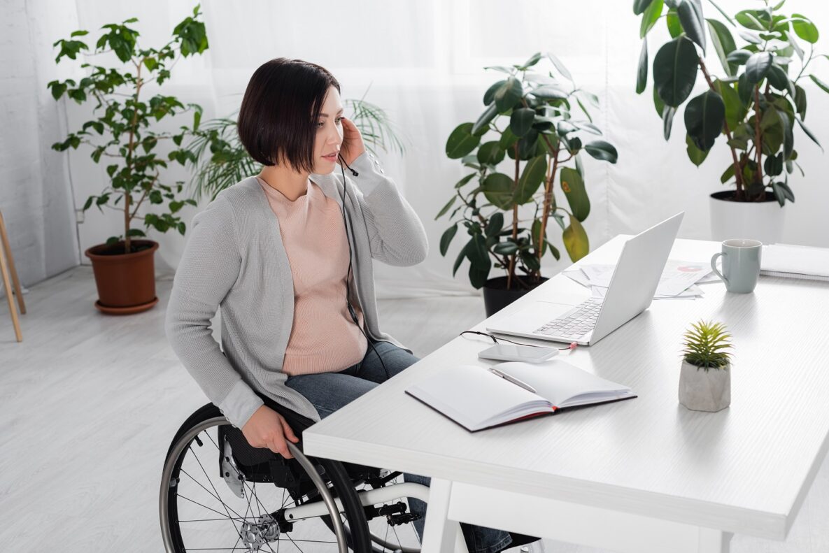 A woman in a wheelchair using her laptop.