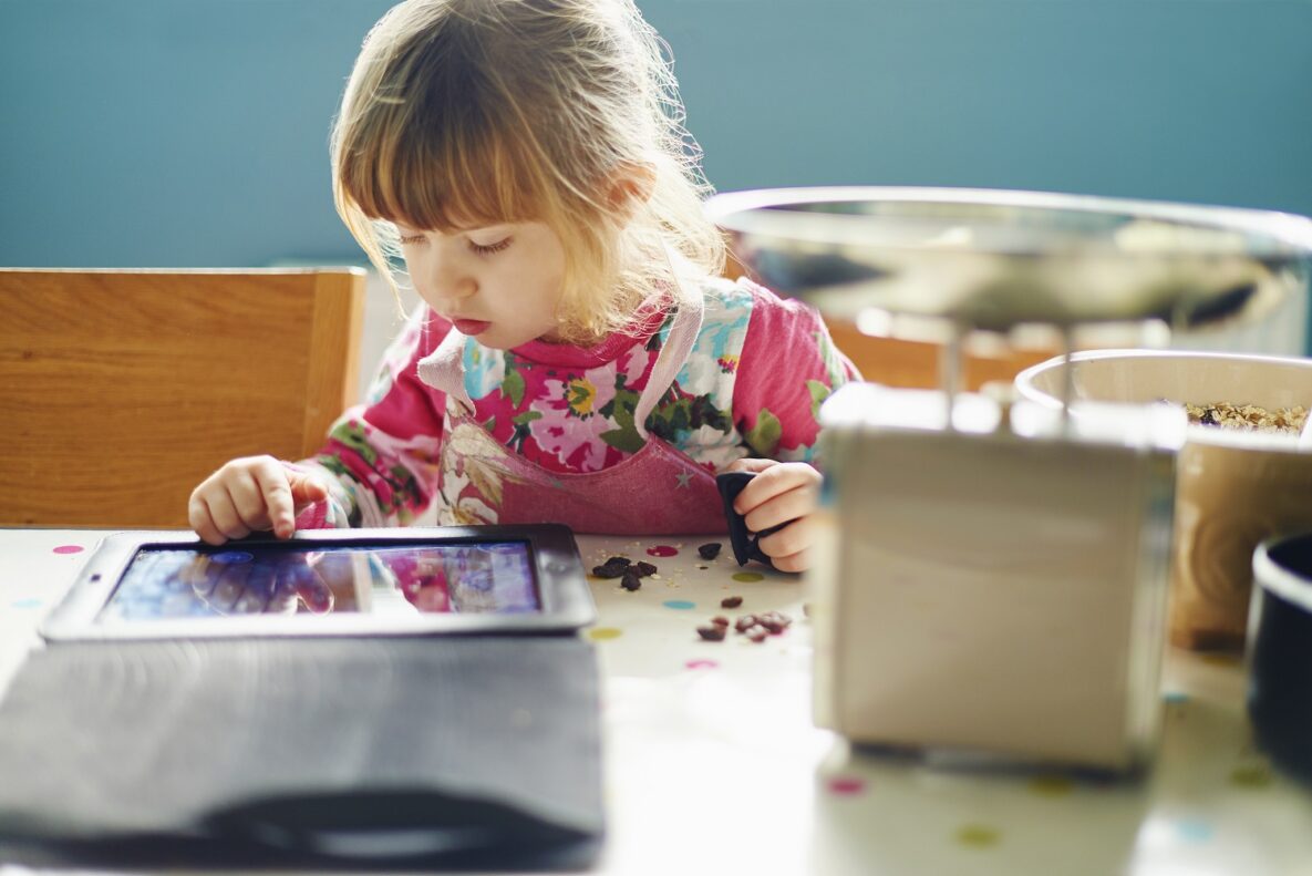 Curious girl using digital tablet.
