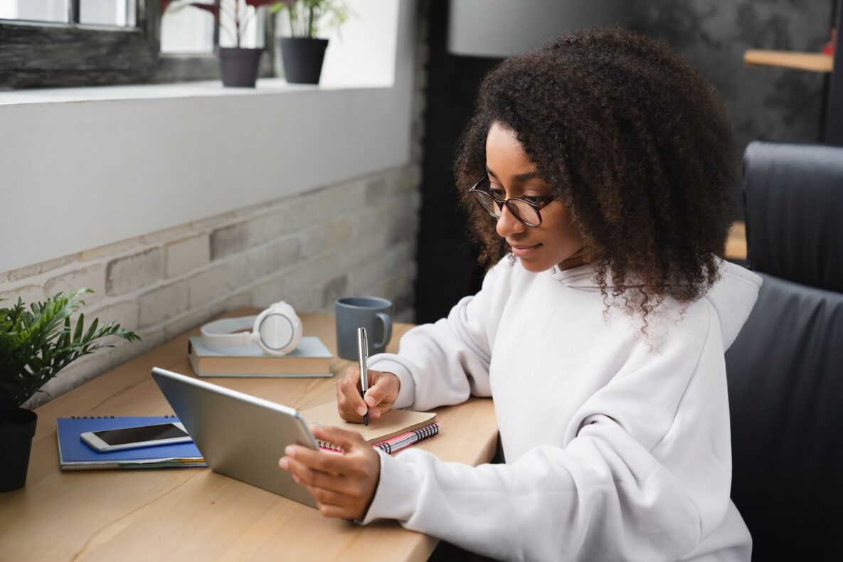 A young woman using her tablet to study.