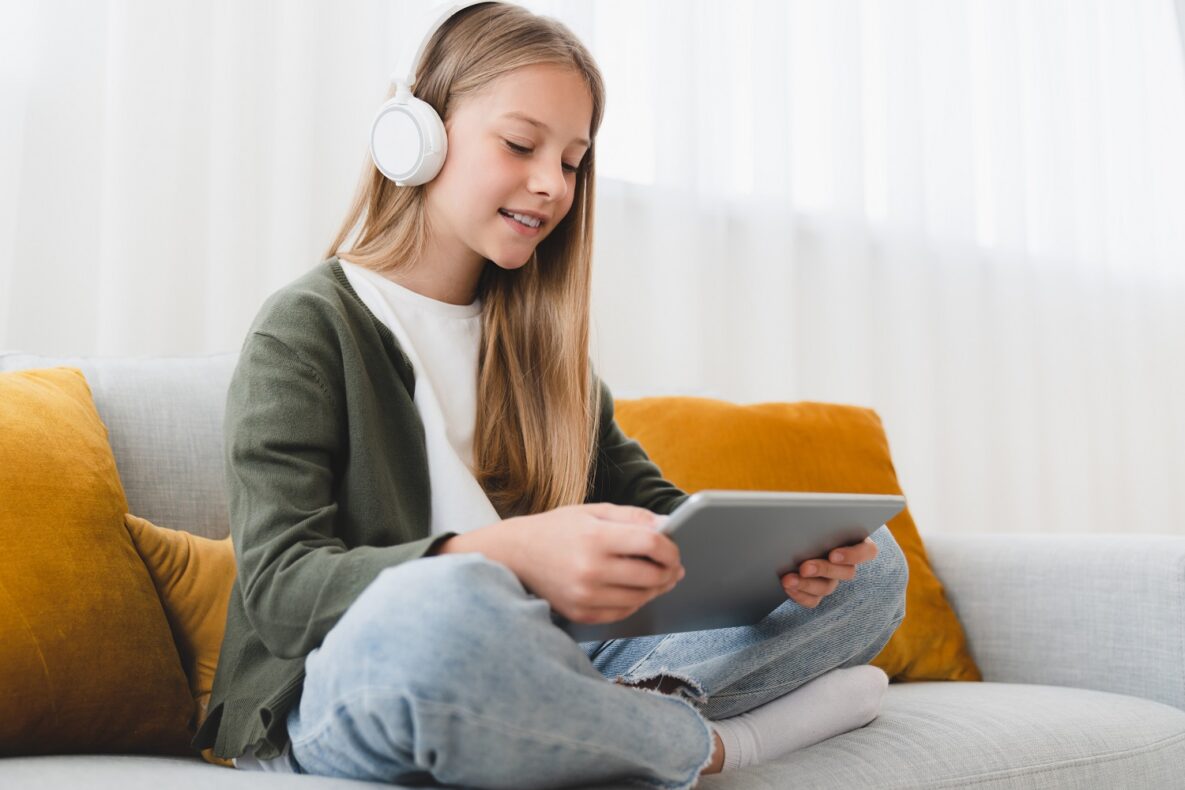 A young person using their tablet at home.