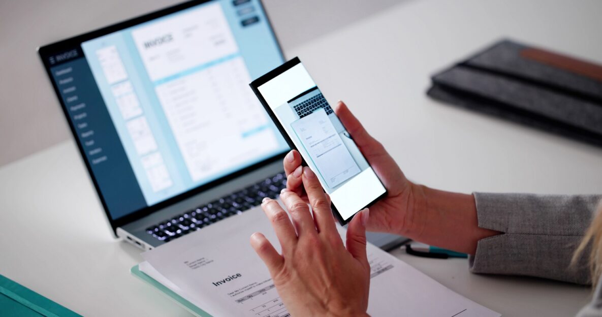 Young woman scanning document with smart phone.