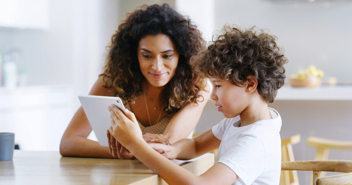 A woman and her son using a tablet together