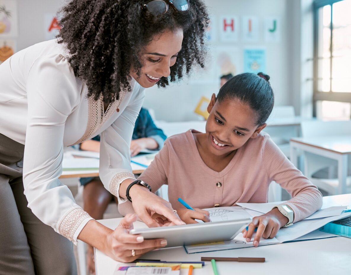 A teacher and student using a tablet in the classroom